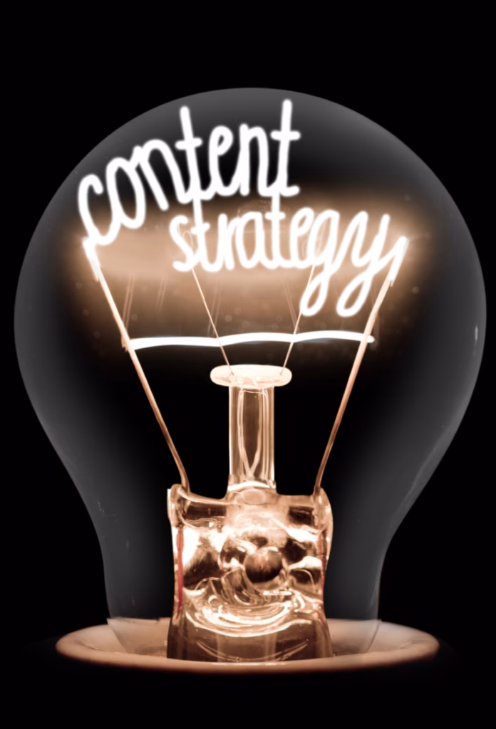 Photo of light bulb with shining fibre in CONTENT STRATEGY shape on black background